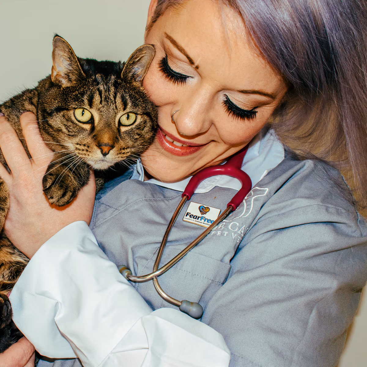 Dr Chantelle McGowan holding a relaxed tabby cat close during a Fear Free consultation